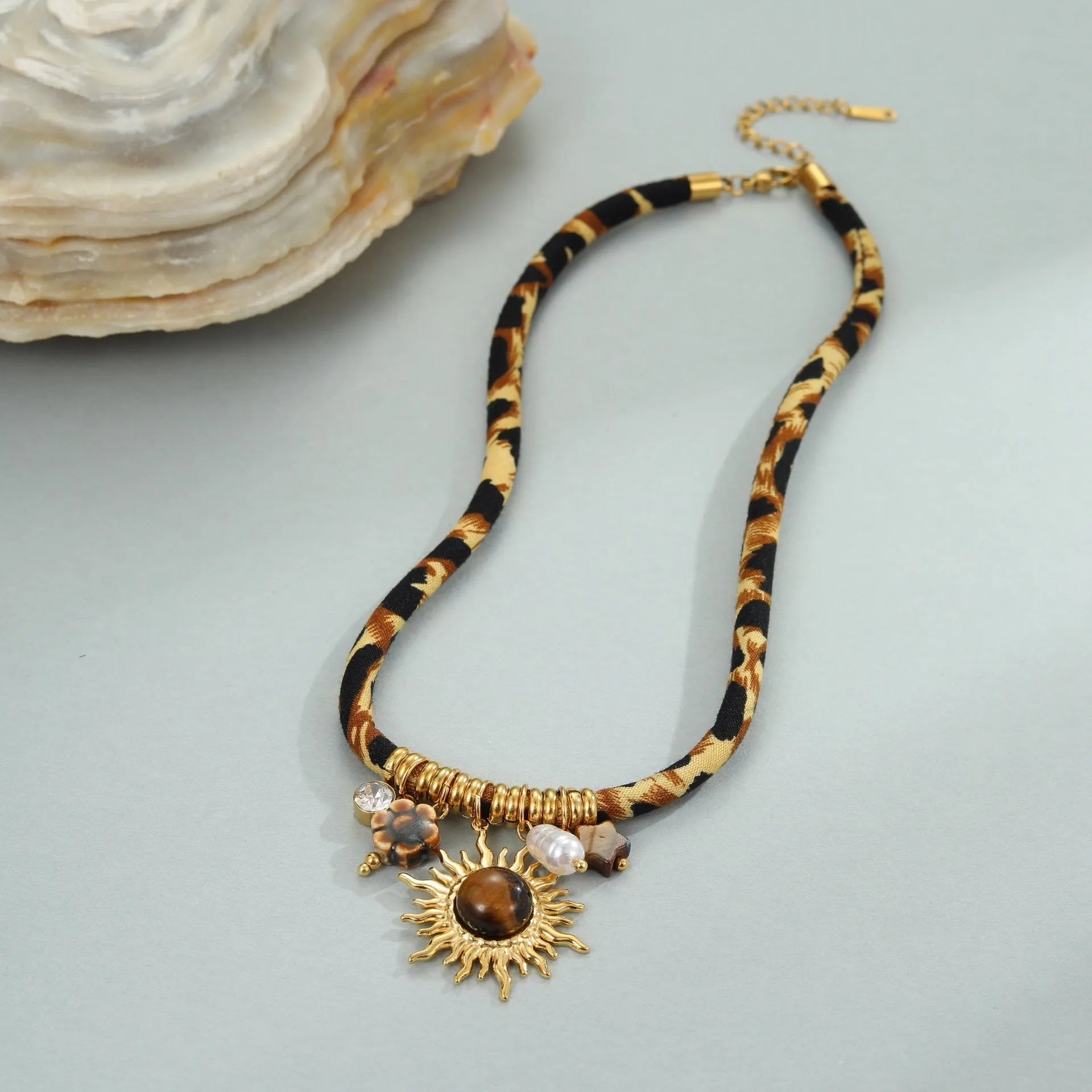 Gold geometric leopard series pendant on an adjustable stainless steel necklace chain.
