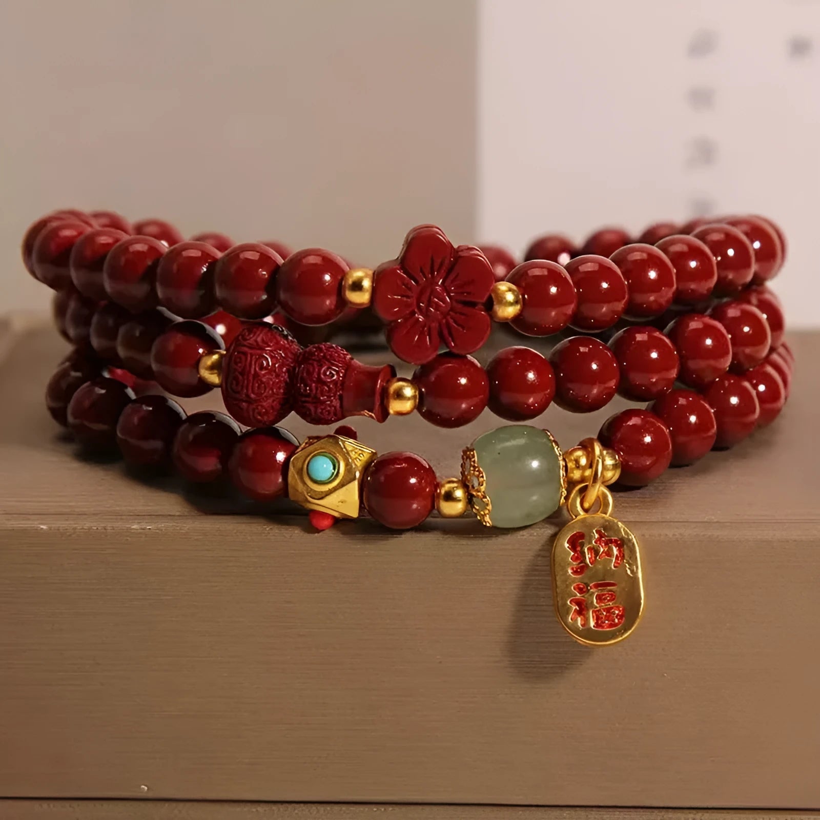 Red cinnabar bracelet with geometric gourd and flower design, 6mm diameter with clasp fastening