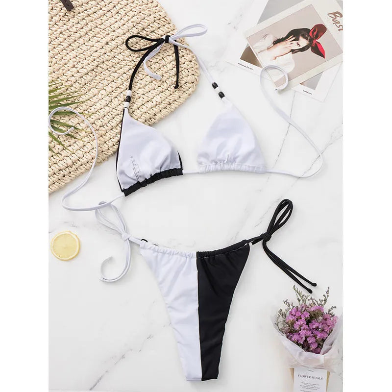 Women's black and white lace-up bikini swimsuit with triangle cup.