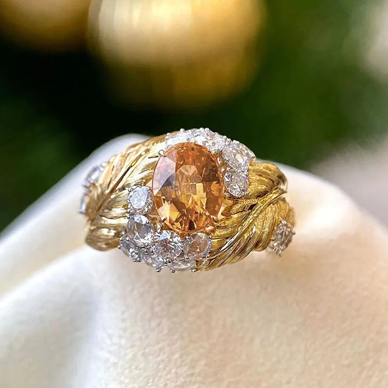 Gold-colour copper embossed feather ring with inlaid yellow zircon, shown in UK size 8