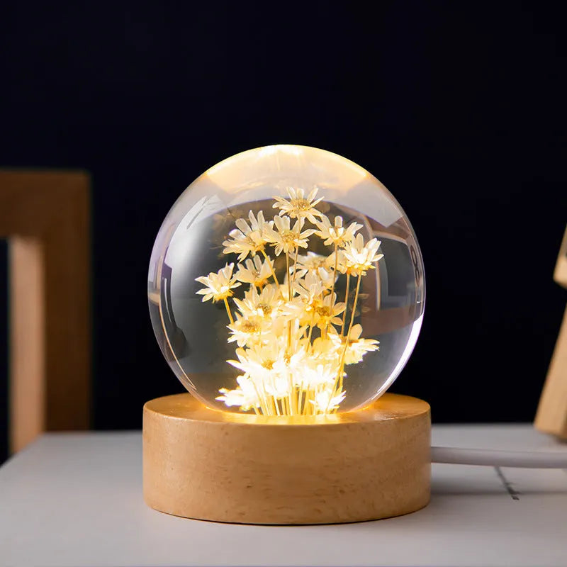 6cm diameter resin crystal ball with preserved dandelion flowers on beech wood stand, USB cable connected