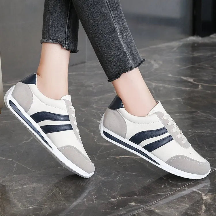 Blue and red low-top lace-up running sneakers with a round toe and rubber sole