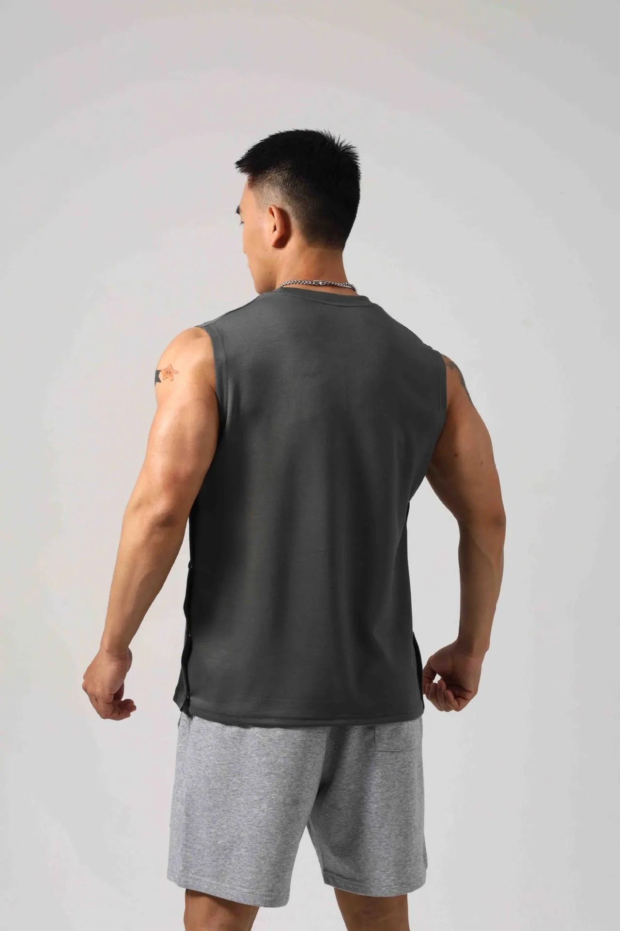 Korean style fitness vest with hidden hook side openings in cotton fabric, shown in black colour
