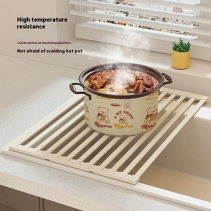 Milky white foldable stainless steel kitchen draining rack with tri-fold design on a sink