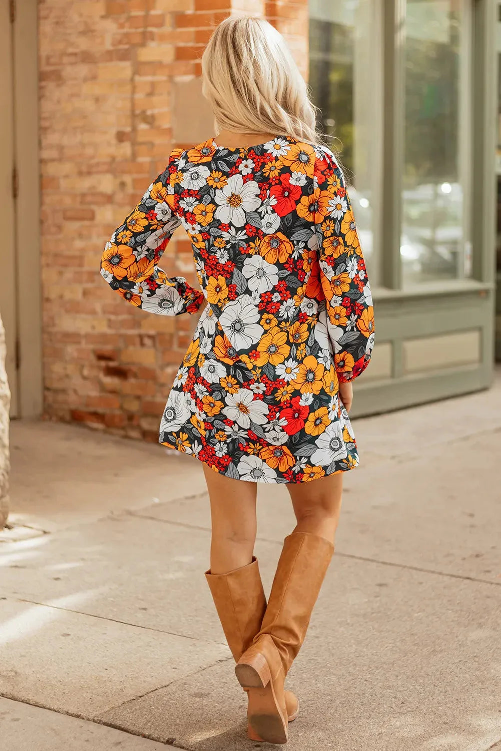 Orange floral and striped print long sleeve V-neck mini dress with lace detail on hanger.