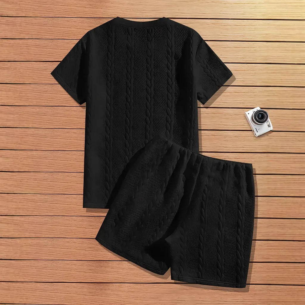 Men's black polyester sports two-piece set with rib short sleeves and a patch design detail.