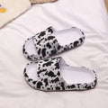 Leopard print slippers with thick EVA sole showing slip-on design and animal pattern details