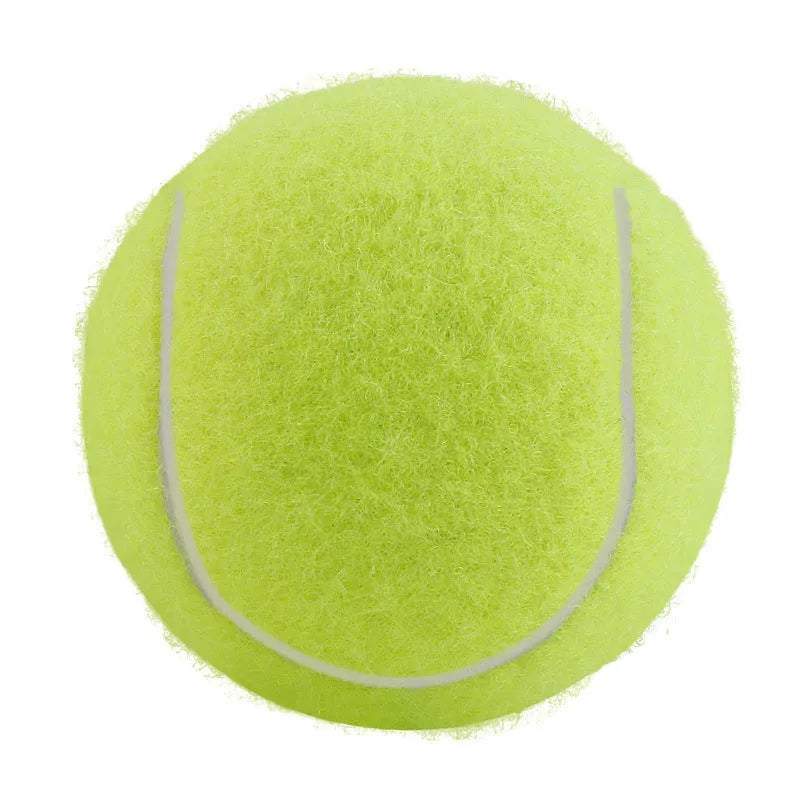 A 6.3cm pink rubber dog tennis ball sitting on grass.
