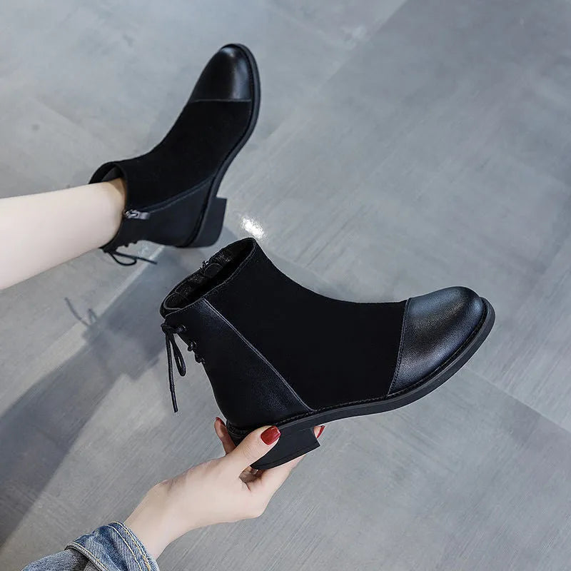 Black women's Martin boots with non-slip rubber soles and side zipper, showing round toe and short stout heel.