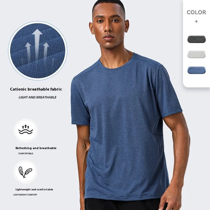 Man wearing a lightweight dark gray short sleeve sports top with reflective details on the sleeves.