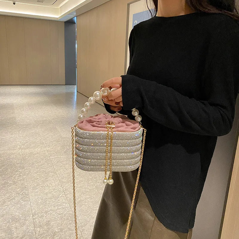 Women's round crossbody bag in soft PU with beaded details, adjustable strap, and zippered interior organiser.