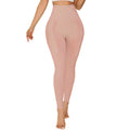 Women's black belly contracting yoga trousers with seamless design on a mannequin