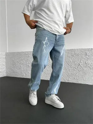 Men's blue straight-leg jeans with a loose wide-leg cut and printed design.