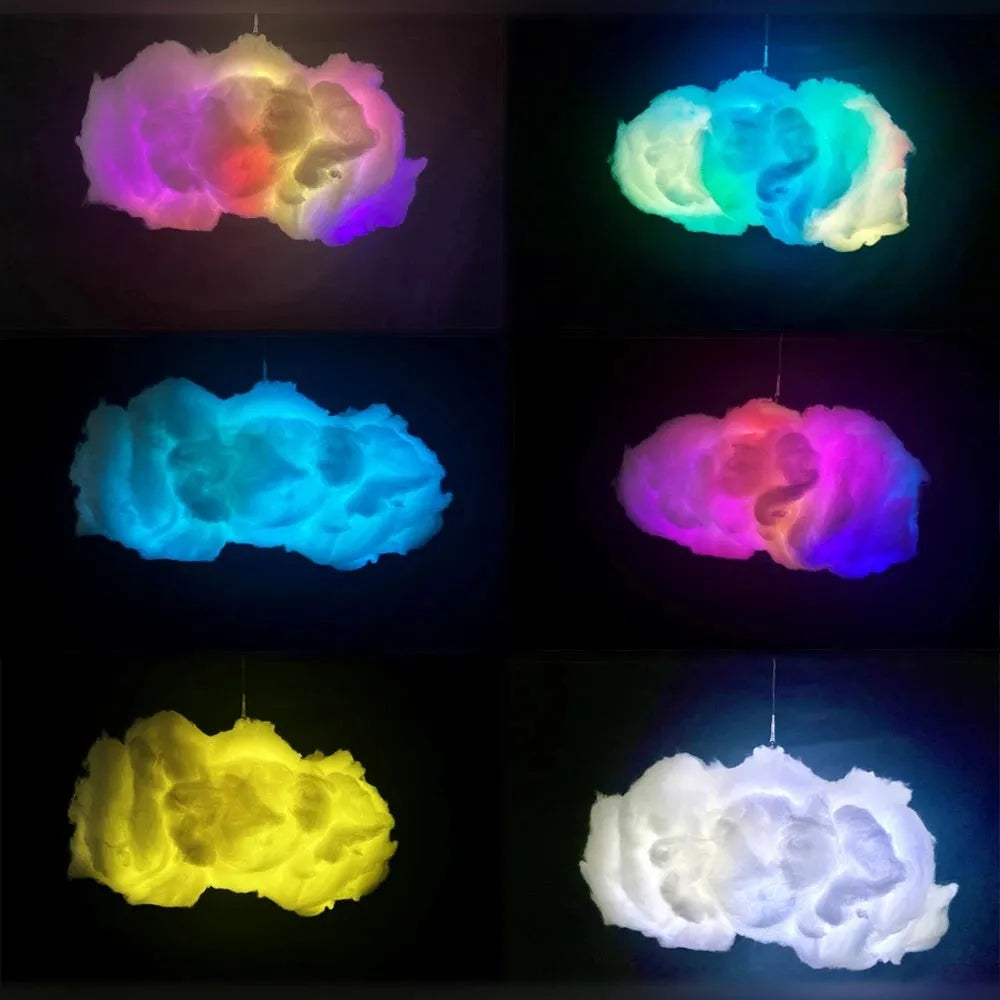 White fabric cloud shaped pendant light with multi-colour LED glow, hanging from a ceiling with a USB cable.