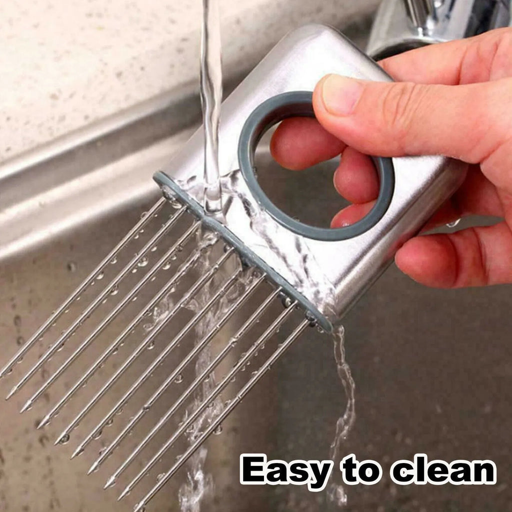 Stainless steel onion holder slicer with sharp prongs and a red finger guard on a kitchen counter.