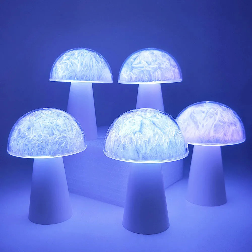 Colourful mushroom-shaped night lamp with remote control on a wooden surface.
