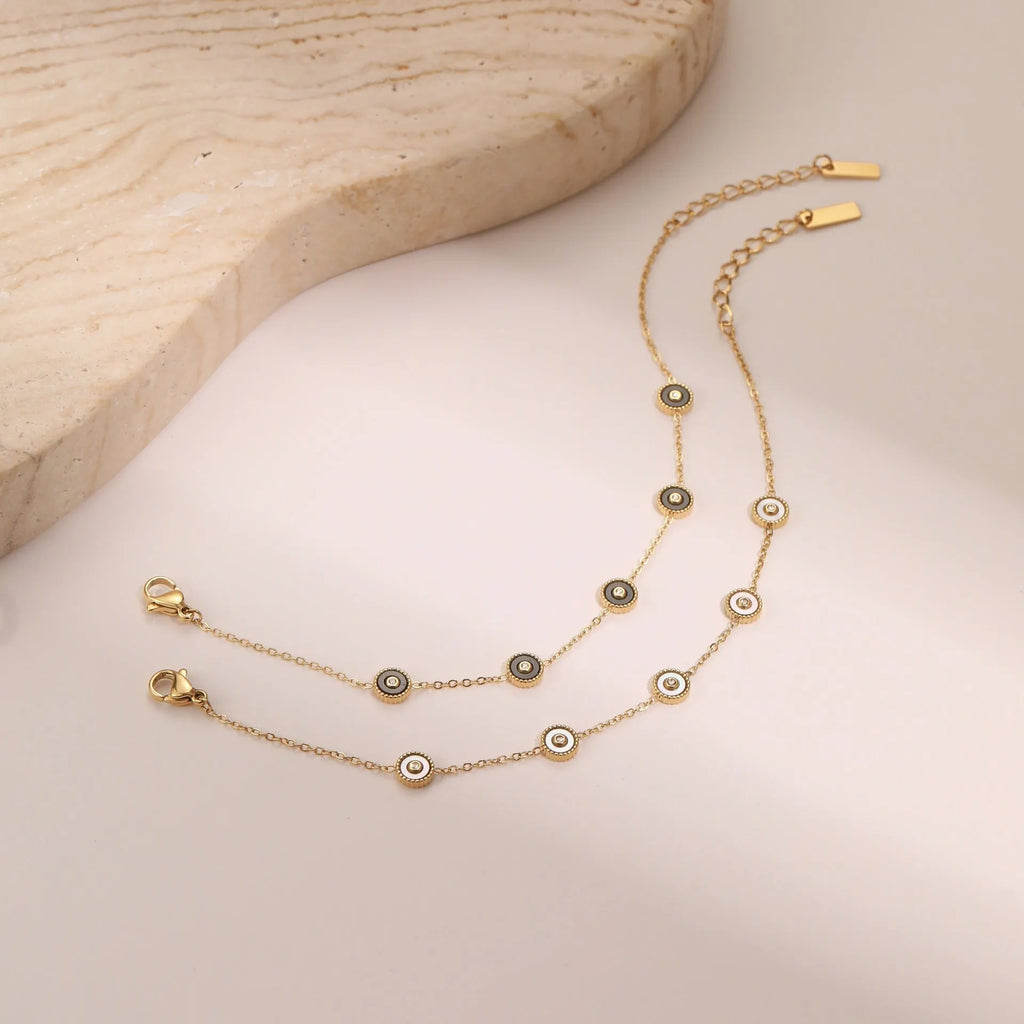 Stainless steel bracelet and necklace set with 18K gold plating and geometric fritillary pattern design