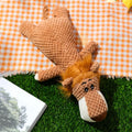 Green plush dog toy with corn kernel texture design for teeth cleaning and interactive sound feature