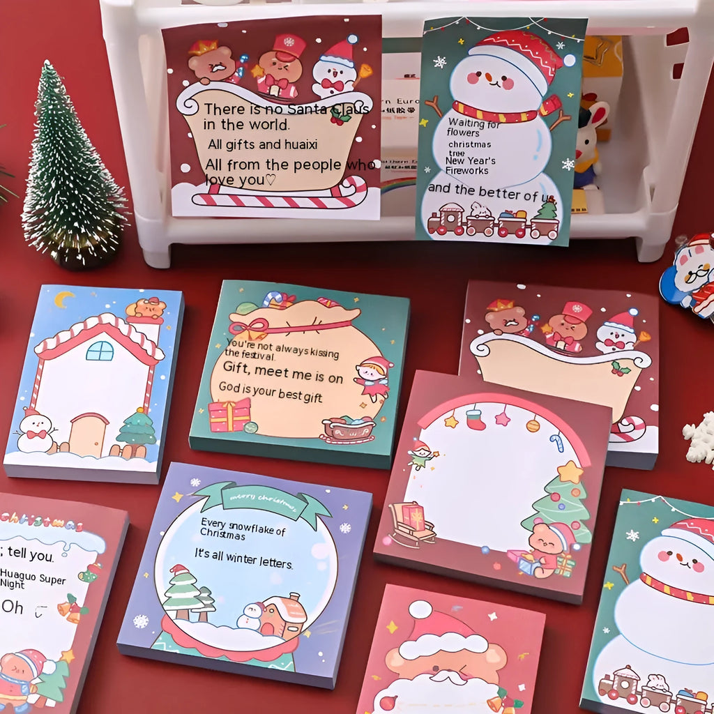 Christmas sticky notes book with eight festive designs including Santa bear elf gift house sled snowman crystal ball