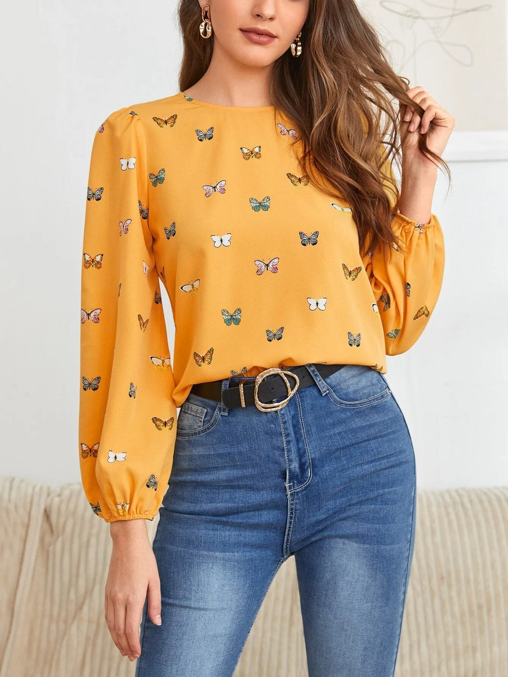 Women's butterfly print long-sleeved shirt in green colour showing loose fit and regular sleeves