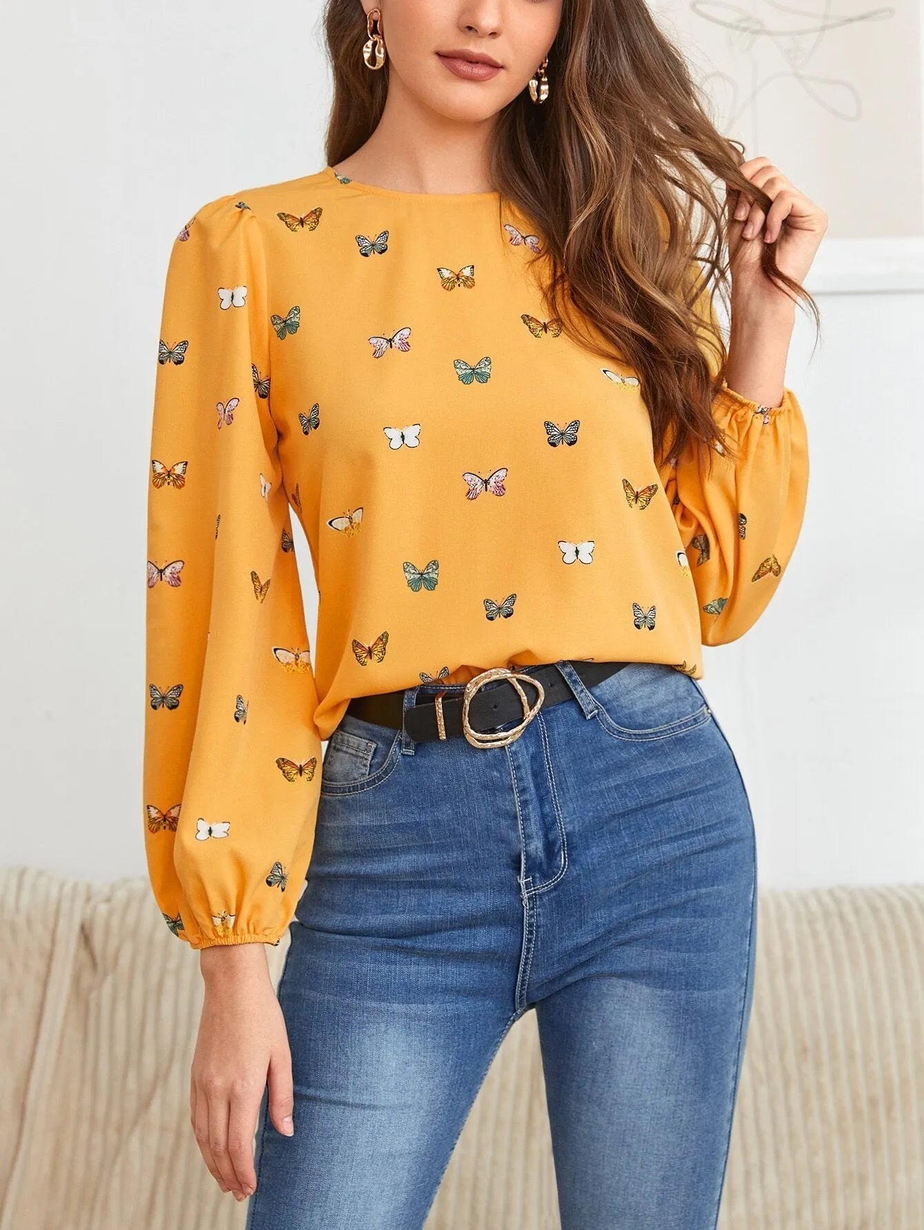 Women's butterfly print long-sleeved shirt in green colour showing loose fit and regular sleeves