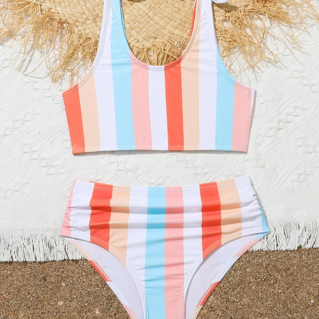 Girls plaid print swimsuit briefs with bra top, shown in multiple toddler and child sizes.