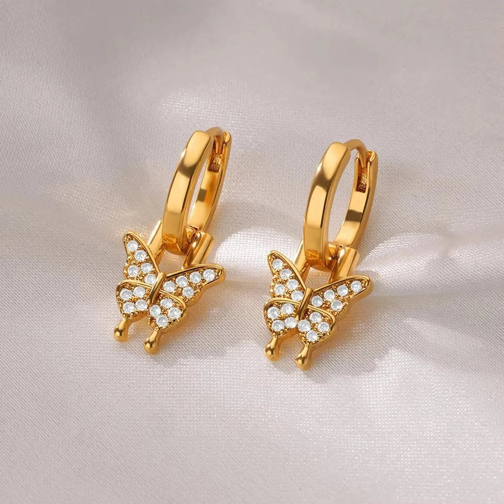 Women's irregular geometric butterfly earrings in copper with diamond treatment, showing heart-shaped and star design elements