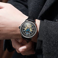 Men's mechanical watch with round dial, stainless steel strap, and transparent case back showing movement.