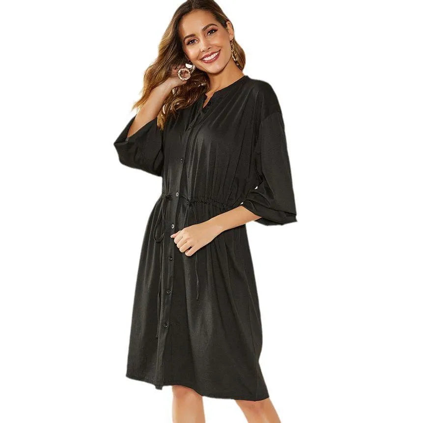 Black A-line dress with elastic waist and cinched belt, mid-length skirt, long sleeves