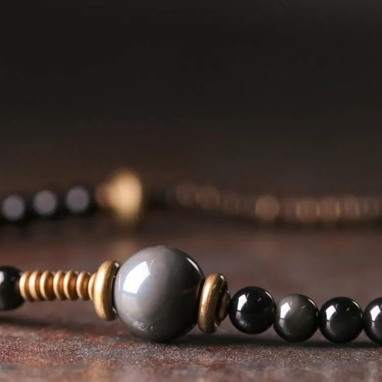 Black multi-layered beaded bracelet with colourful geometric and natural style beads.