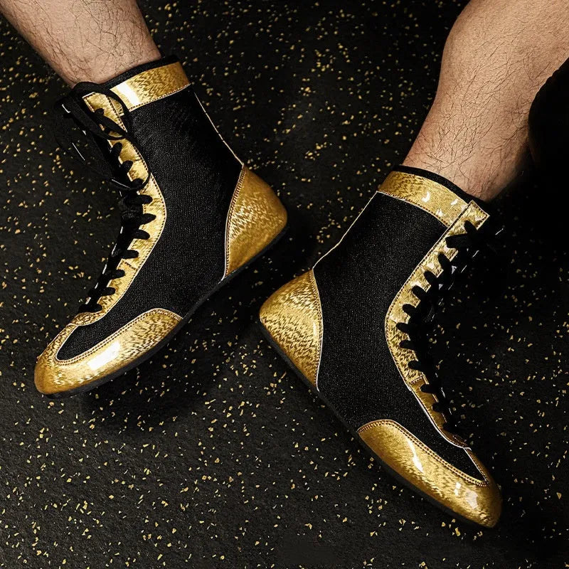 Professional black and gold mesh boxing shoes with leather upper and rubber sole.