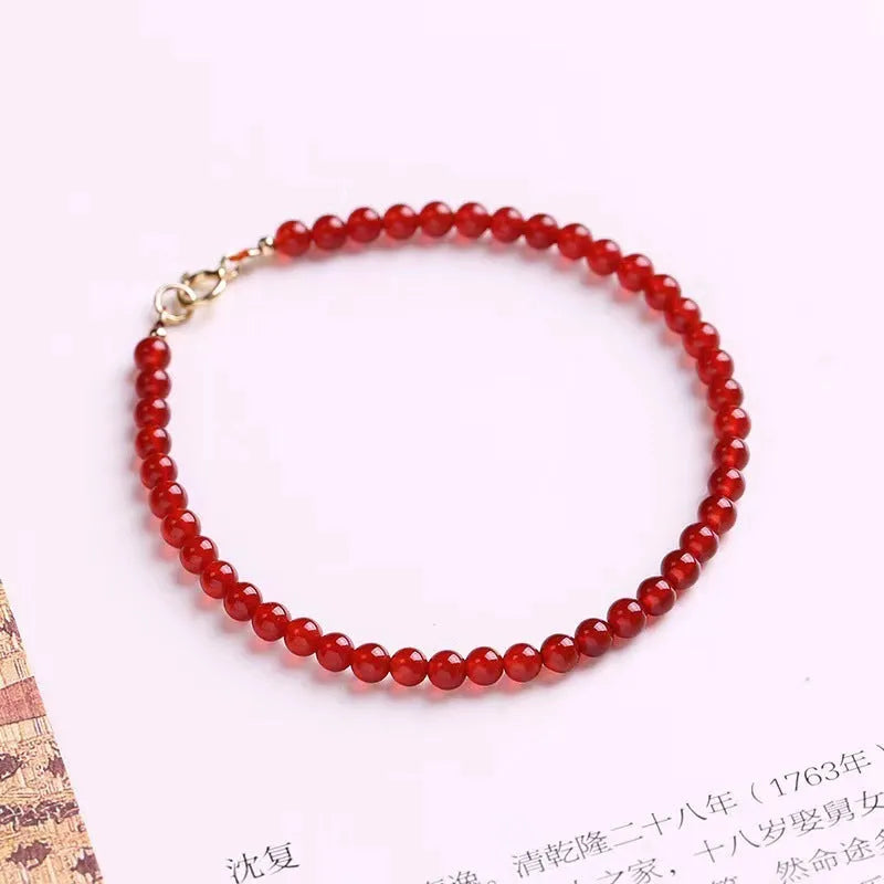 A red agate bracelet for women with an ultra-thin, delicate design on a wrist.