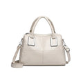 Simple square women's shoulder bag in neutral colour with internal phone and file pockets.