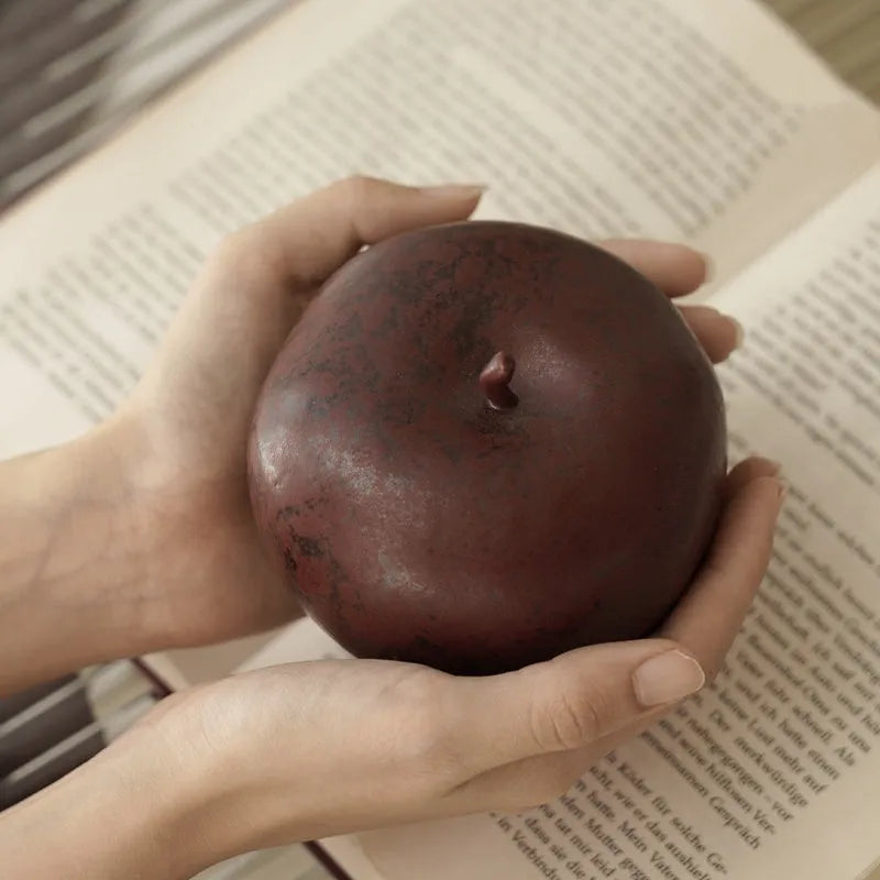 Retro Chinese ceramic simulation apple ornament on desktop, showing authentic details and ceramic construction