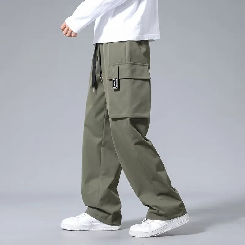 Boys' straight leg cargo trousers in army green with large cargo pockets and a drawstring waistband.