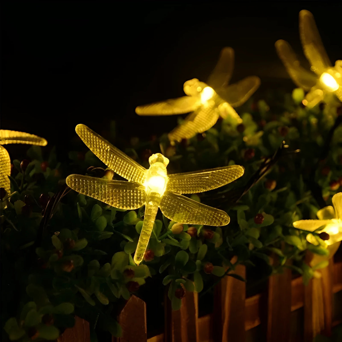 5-metre long solar-powered dragonfly string lights with warm white LEDs and a ground-spike solar panel for outdoor use.