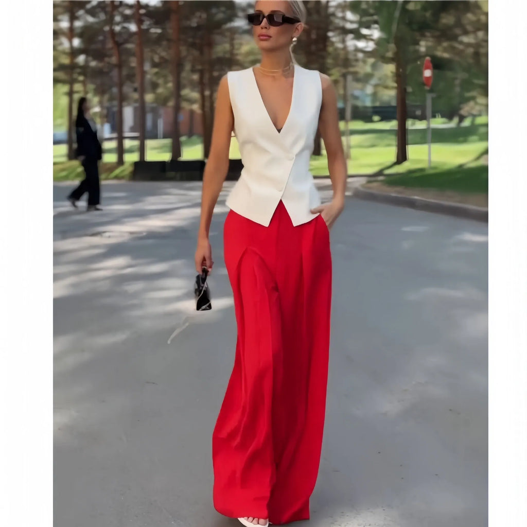 Beige women's sleeveless deep V-neck top and high-waist wide-leg trousers two-piece set on a hanger.