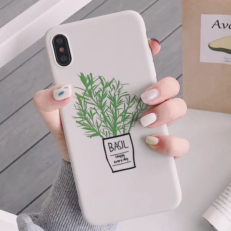 White silicone iPhone case with a detailed painted leaf and plant pattern on the back.