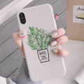 White silicone iPhone case with a detailed painted leaf and plant pattern on the back.