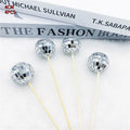 Glass disco ball cake decoration on wooden stick in silver reflective finish