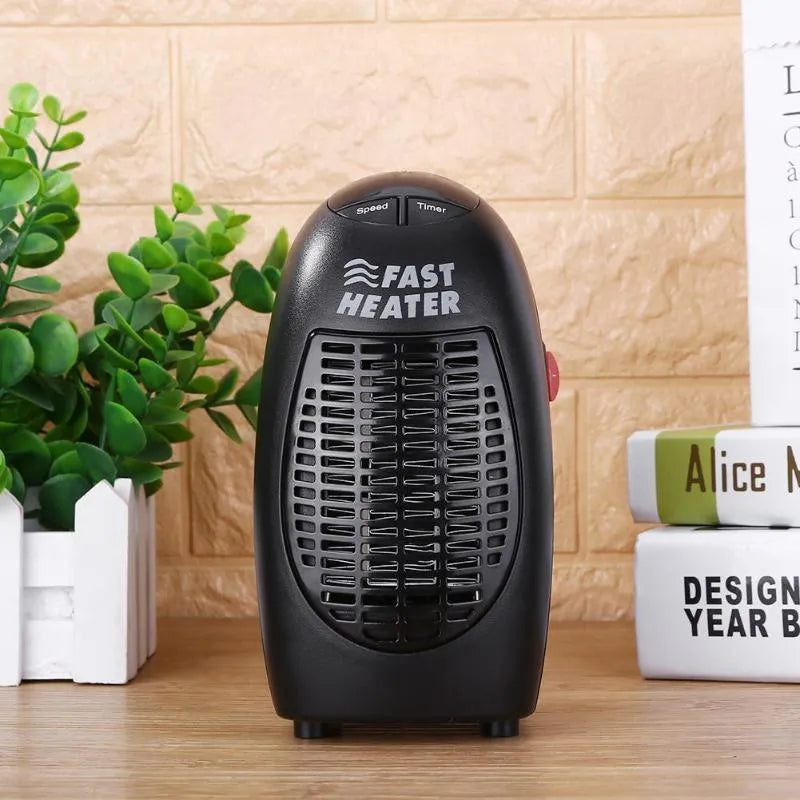 Black compact electric heater with digital display and rotating plug on a desk