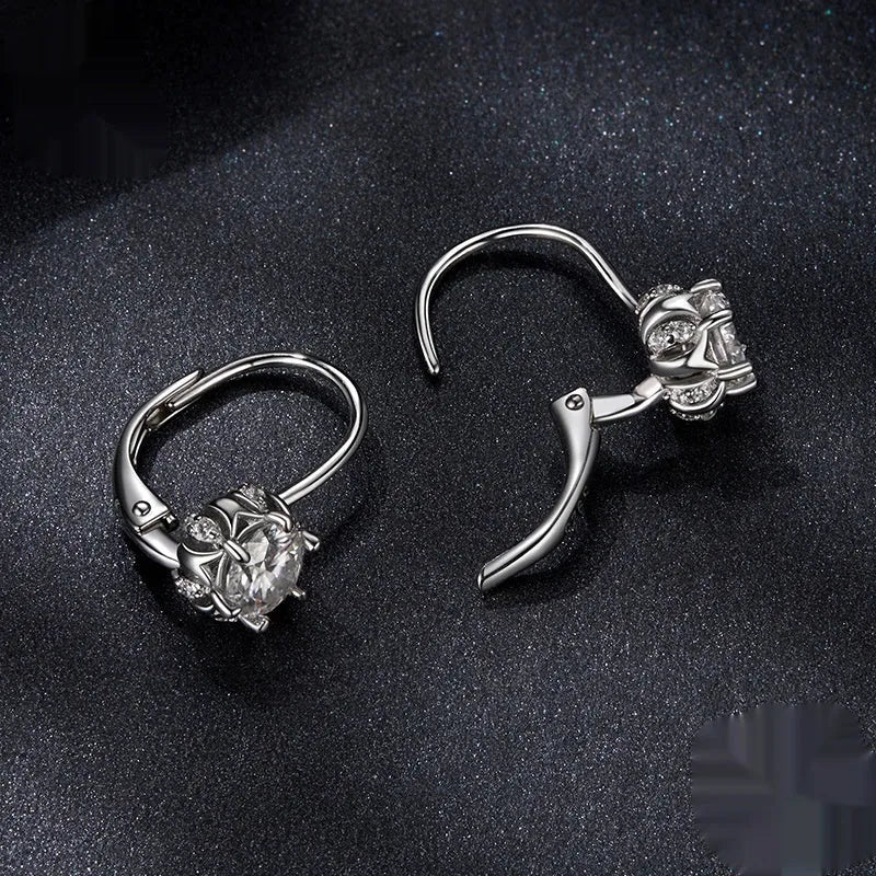 Close-up of a sterling silver floral ear clip with moissanite stone and white gold plating
