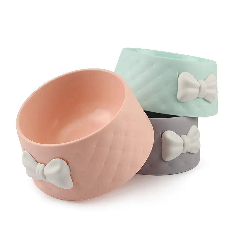 Bow-shaped cat bowl dog bowl in PP plastic, shown in pink, green, and grey.