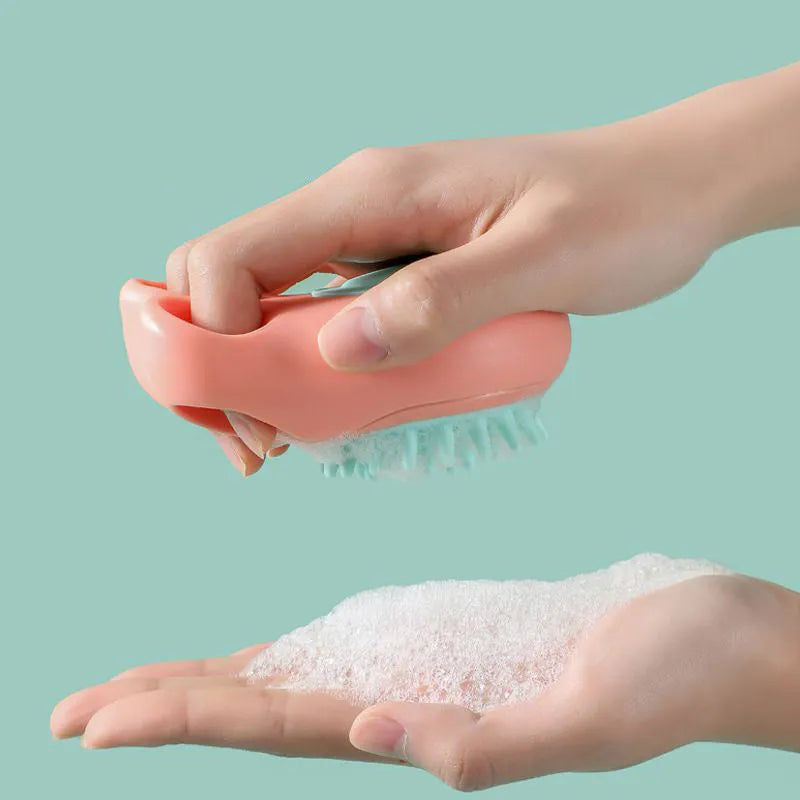 Blue pet bath and massage brush with soft silicone bristles and a plastic handle for cats and dogs.