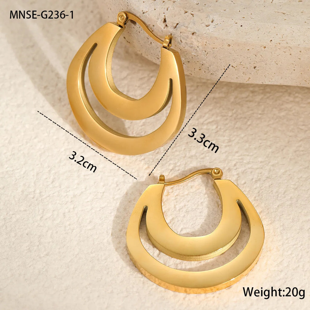 A pair of geometric minimalist French earrings in a round ring design, shown in both gold and steel metallic finishes.