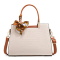 Women's milky white shoulder handbag with three interior compartments showing zipper changing bag, mobile phone pocket, and document storage