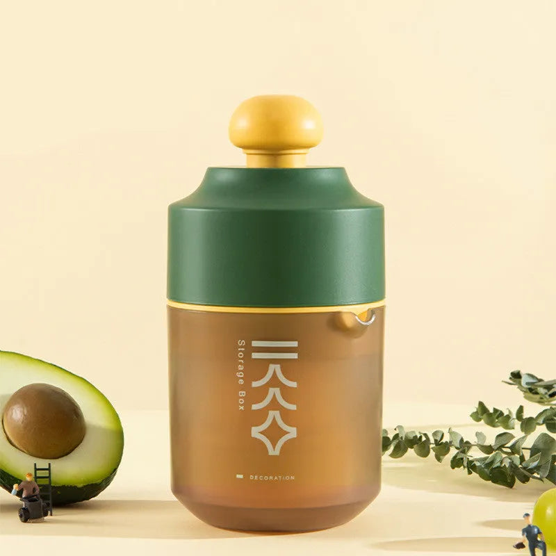 Green, pink and white manual plastic citrus juicer with 400ml capacity for portable use.