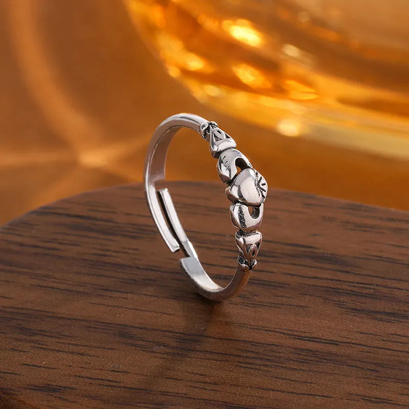 Retro silver coloured open band heart ring made of copper for women.