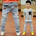 Boy wearing striped denim harem pants with an elasticated waistband, casual style for spring and autumn.