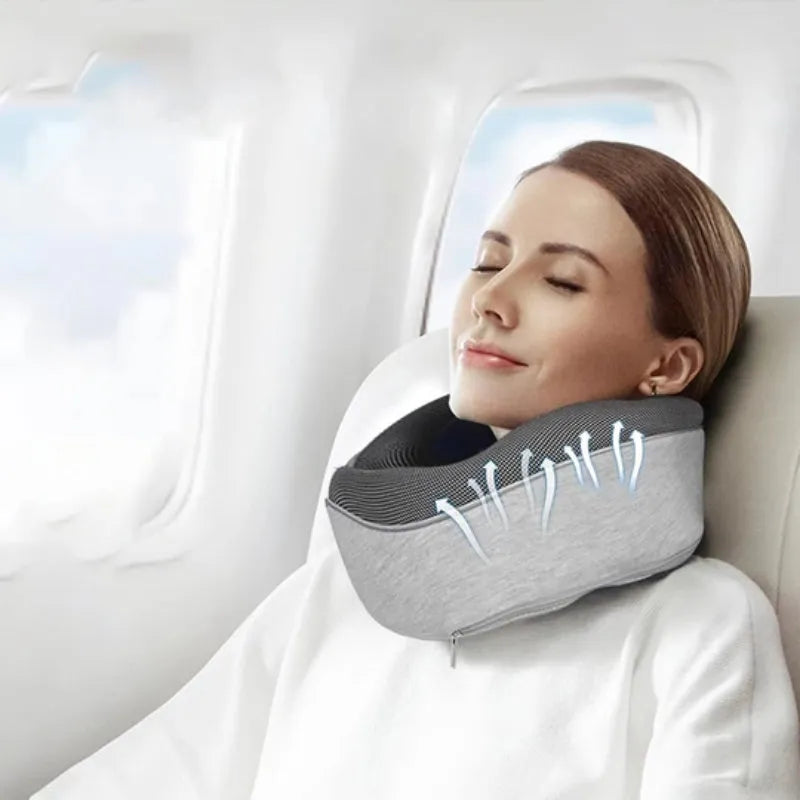 Navy blue U-shaped travel neck pillow with memory foam filling shown rolled and in its carry bag